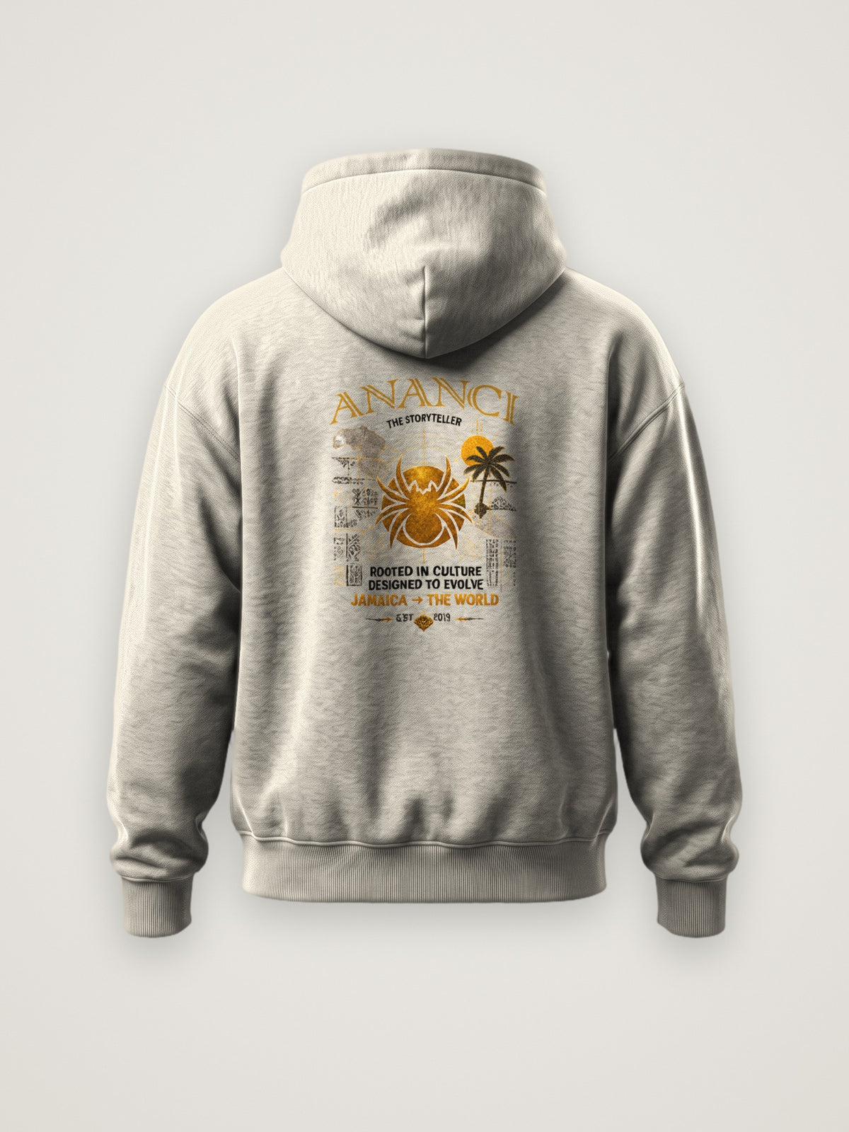 Back of the cream ANANCI The Storyteller Hoodie with the The Storyteller graphic with gold spider, island map, palm and Jamaica to the world lettering