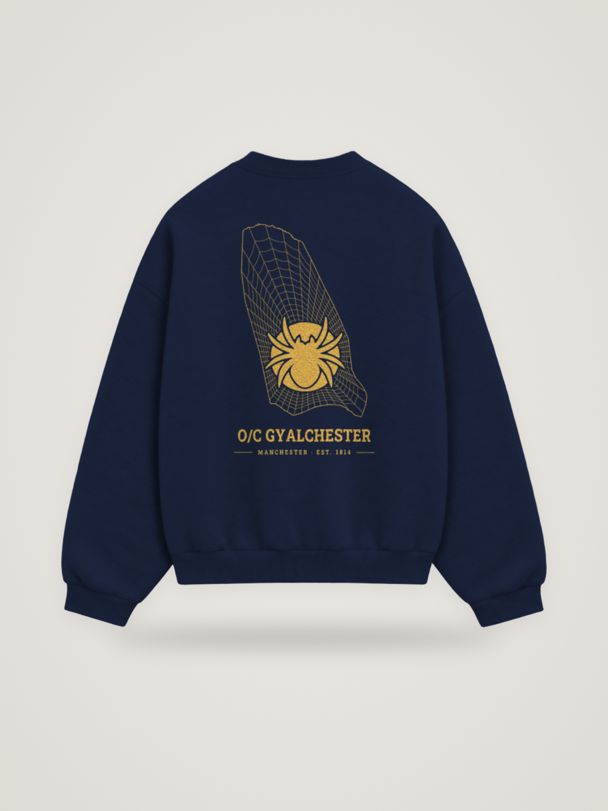 Back of the midnight ANANCI Where Yuh From? Manchester crewneck with the Manchester map, web and spider in gold ink, “O/C GYALCHESTER” and MANCHESTER · EST. 1814