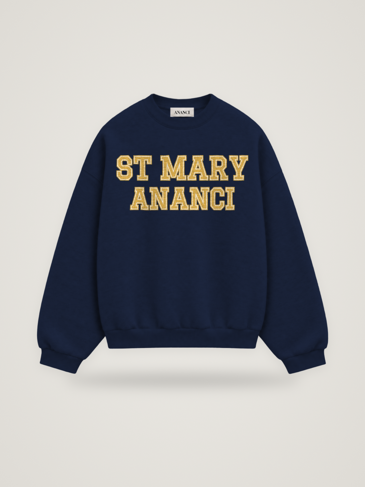 Front of the midnight ANANCI Where Yuh From? St Mary crewneck with straight two-tone varsity lettering, gold with a cream inline, reading ST MARY over ANANCI