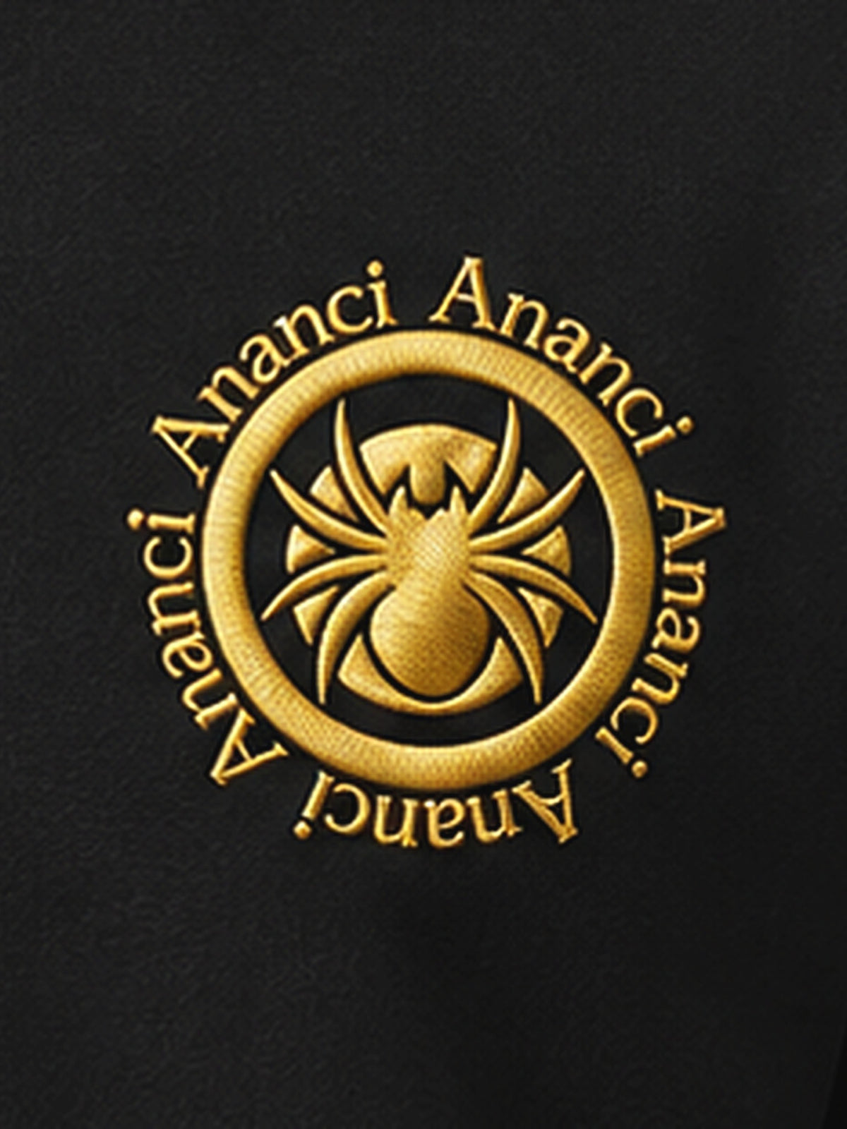 Close-up of the gold ANANCI seal: the spider ringed in the Ananci name on black