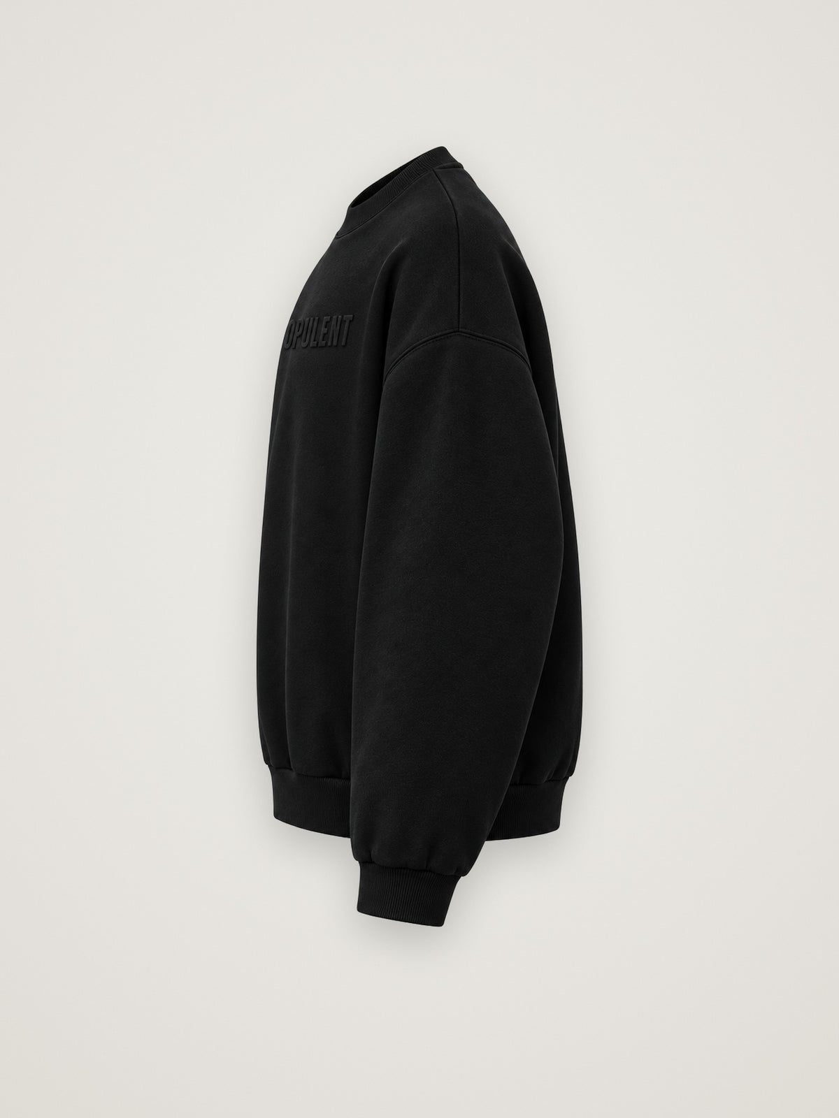 Side profile of the black ANANCI Opulent crewneck showing the drop shoulder and ribbed cuff