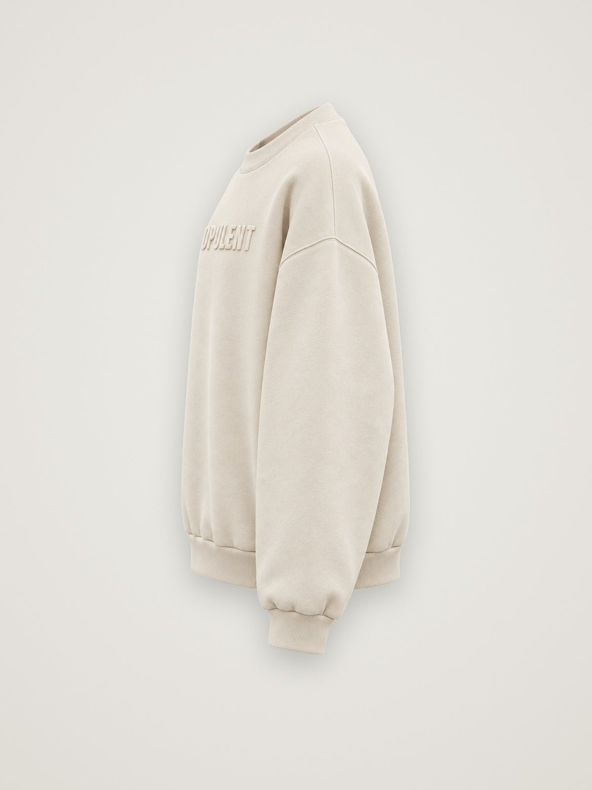 Side profile of the cream ANANCI Opulent crewneck showing the drop shoulder and ribbed cuff
