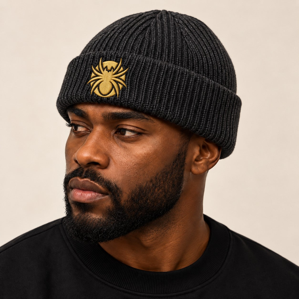 Ananci Signature Beanie in charcoal with gold embroidered spider patch