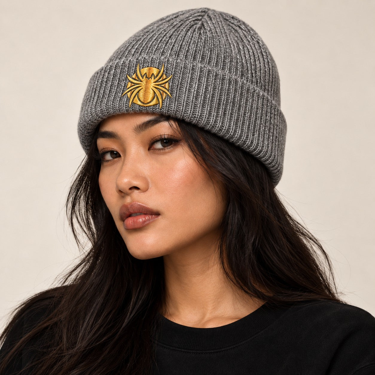 Ananci Signature Beanie in heather gray with gold embroidered spider patch
