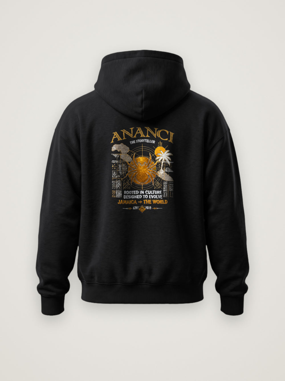 Back of the black ANANCI The Storyteller Hoodie with the The Storyteller graphic with gold spider, island map, palm and Jamaica to the world lettering