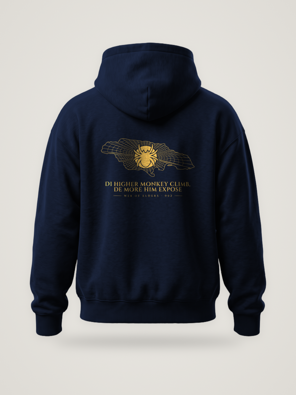 Back of the midnight ANANCI Web of Elders 002 hoodie with “Di Higher Monkey Climb, De More Him Expose” in gold under a spider on a web-lined map of Jamaica