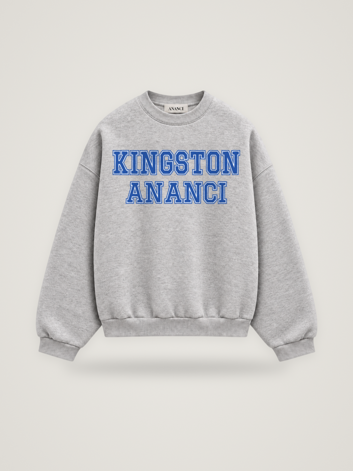 Front of the heather grey ANANCI Where Yuh From? Kingston crewneck with straight two-tone varsity lettering, cobalt with a white inline, reading KINGSTON over ANANCI