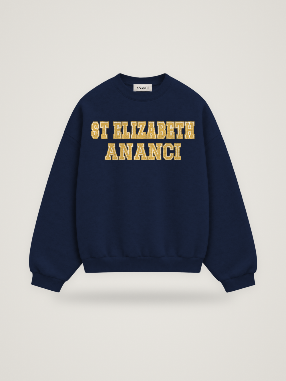 Front of the midnight ANANCI Where Yuh From? St Elizabeth crewneck with straight two-tone varsity lettering, gold with a cream inline, reading ST ELIZABETH over ANANCI