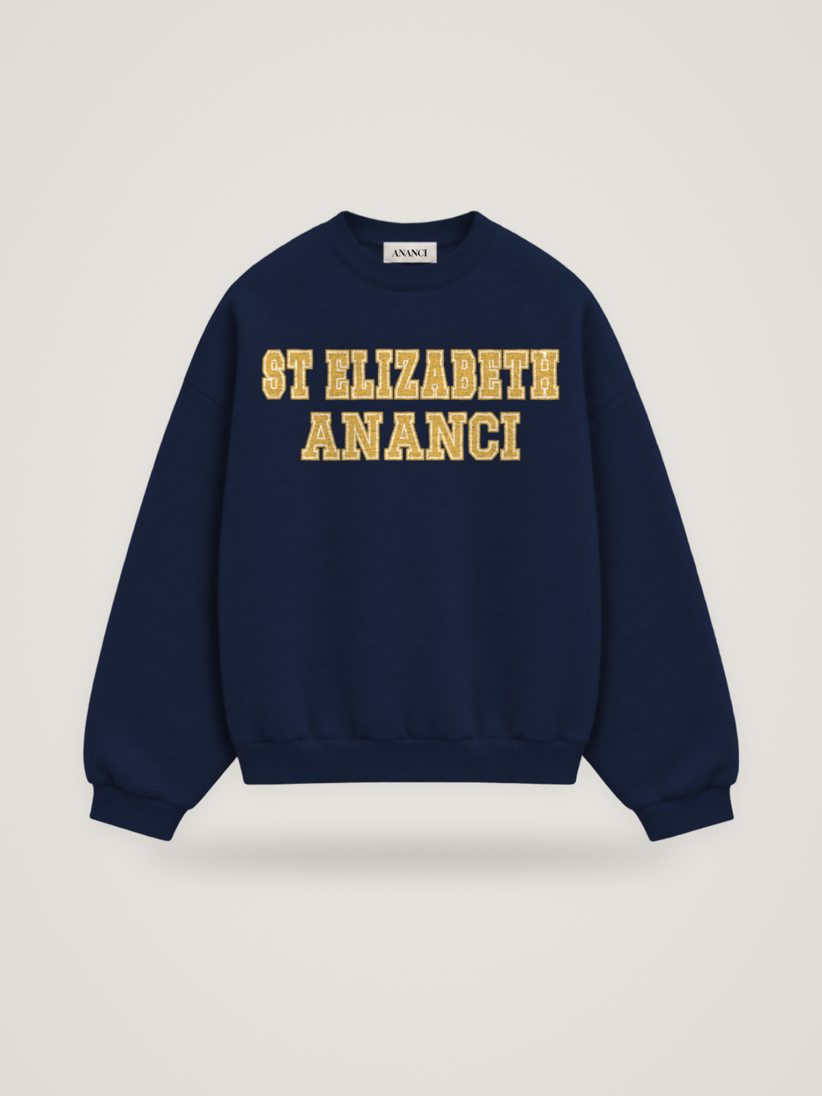 Front of the midnight ANANCI Where Yuh From? St Elizabeth crewneck with straight two-tone varsity lettering, gold with a cream inline, reading ST ELIZABETH over ANANCI