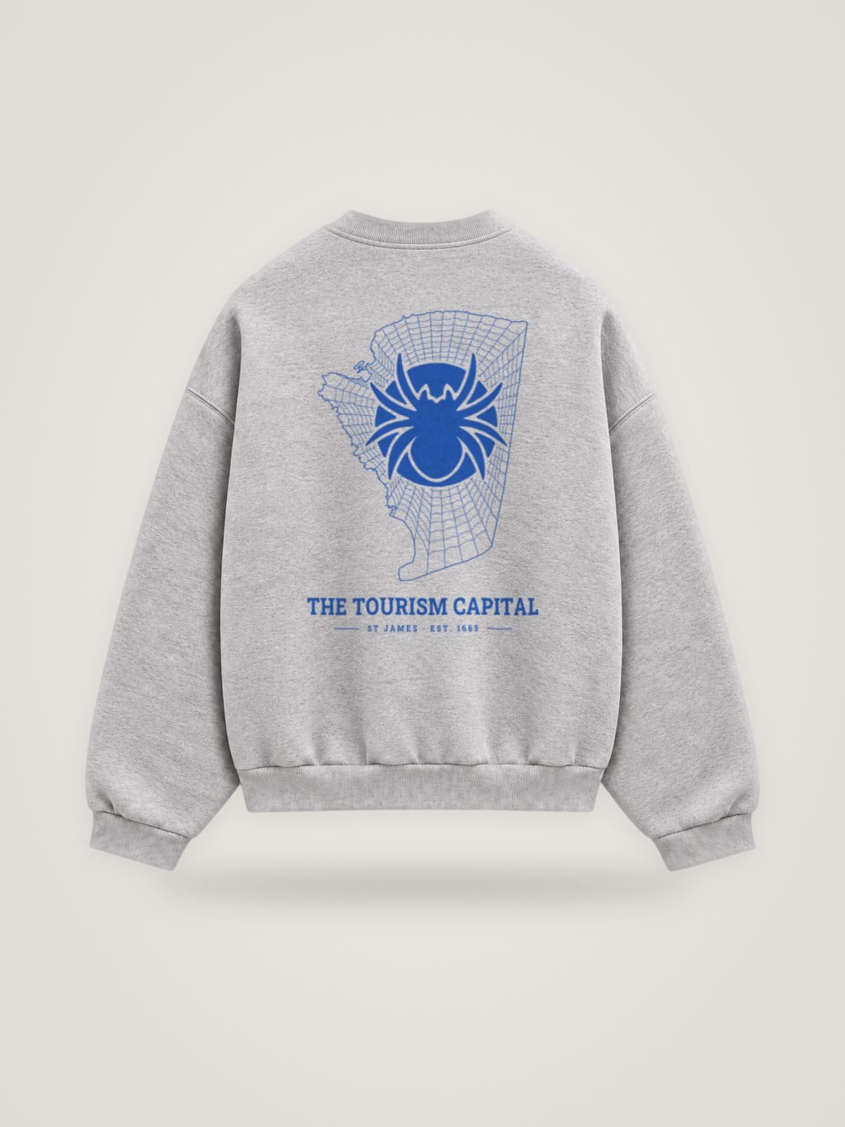 Back of the heather grey ANANCI Where Yuh From? St James crewneck with the St James map, web and spider in cobalt ink, “THE TOURISM CAPITAL” and ST JAMES · EST. 1665