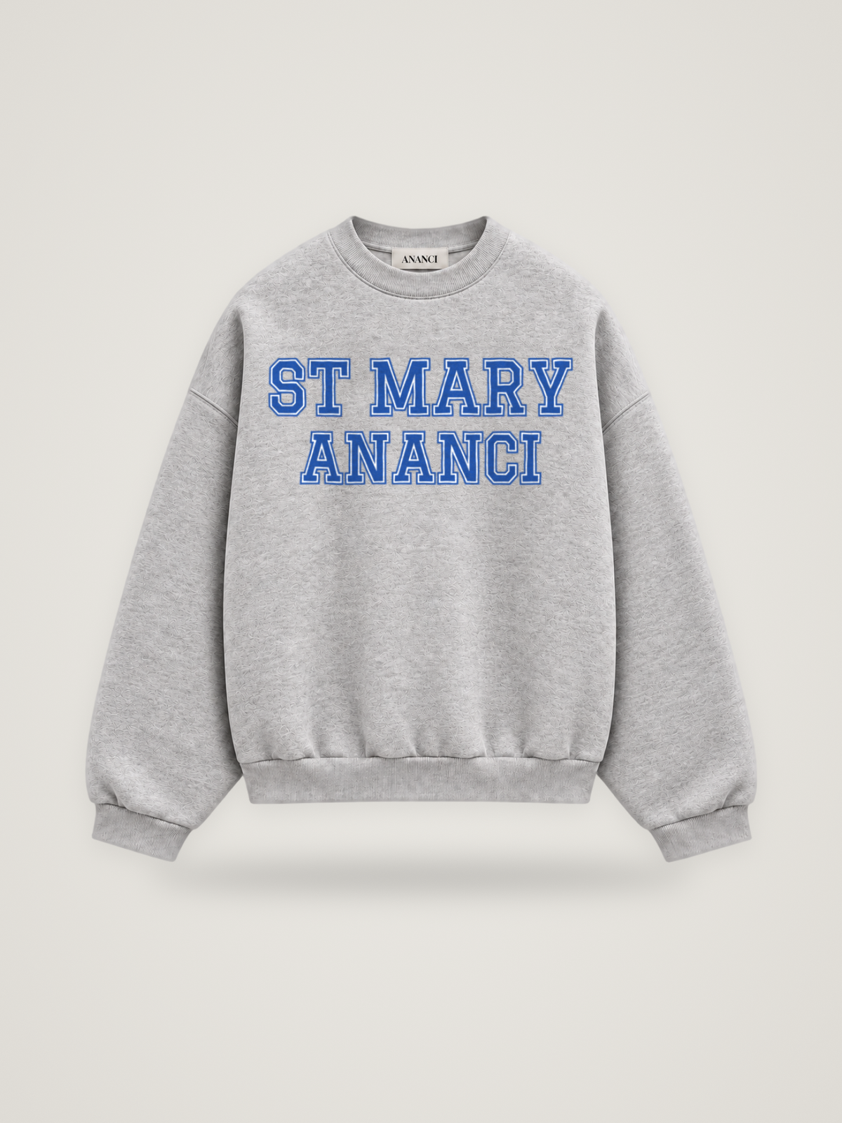 Front of the heather grey ANANCI Where Yuh From? St Mary crewneck with straight two-tone varsity lettering, cobalt with a white inline, reading ST MARY over ANANCI