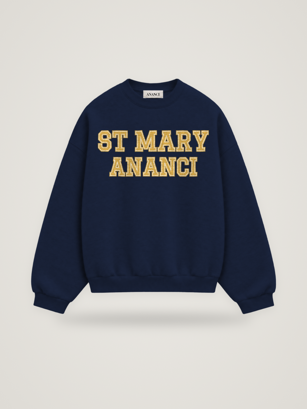Front of the midnight ANANCI Where Yuh From? St Mary crewneck with straight two-tone varsity lettering, gold with a cream inline, reading ST MARY over ANANCI