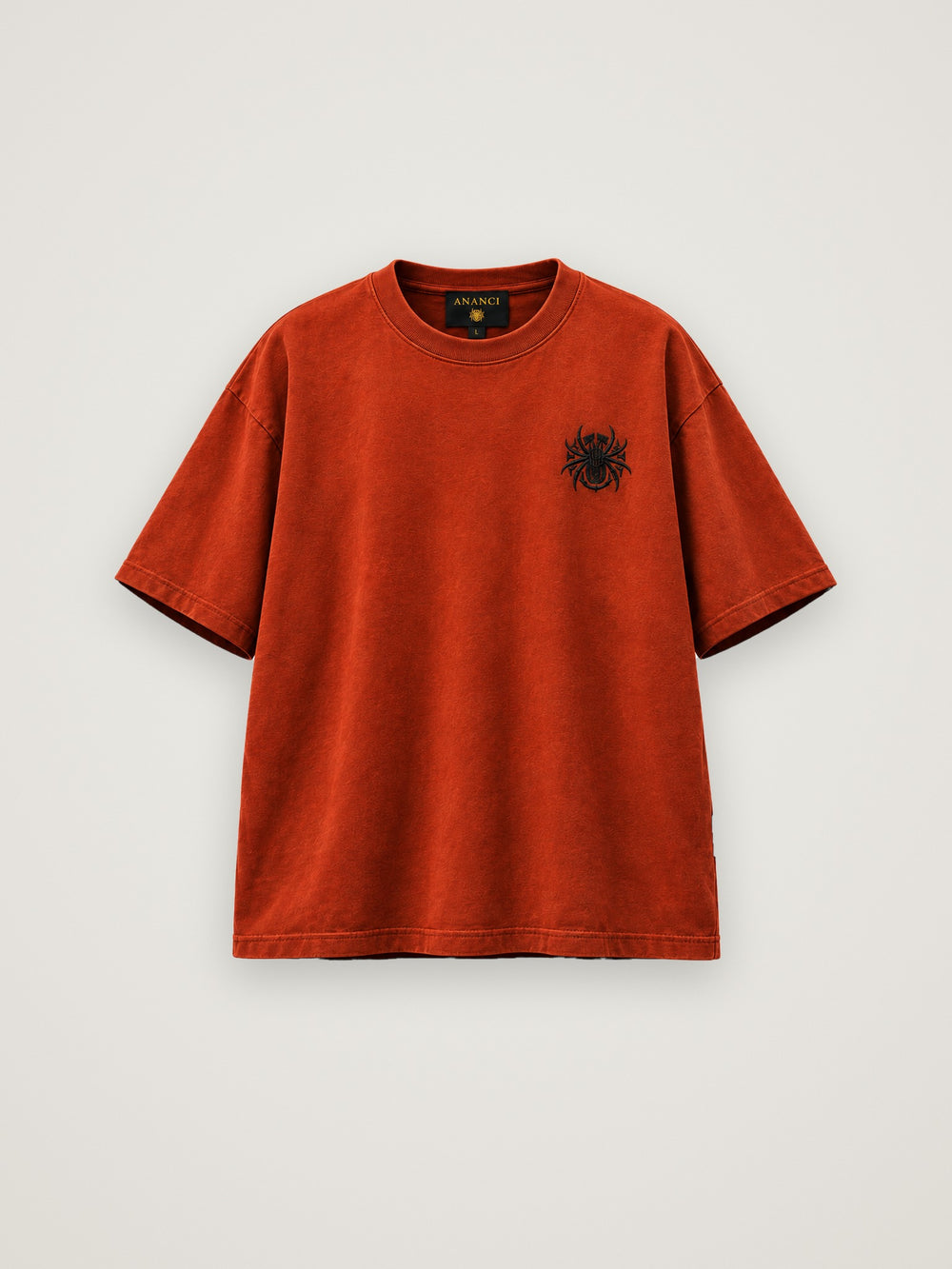 ANANCI "Archive 001" tee in deep rust, front view with the small spider emblem at the chest