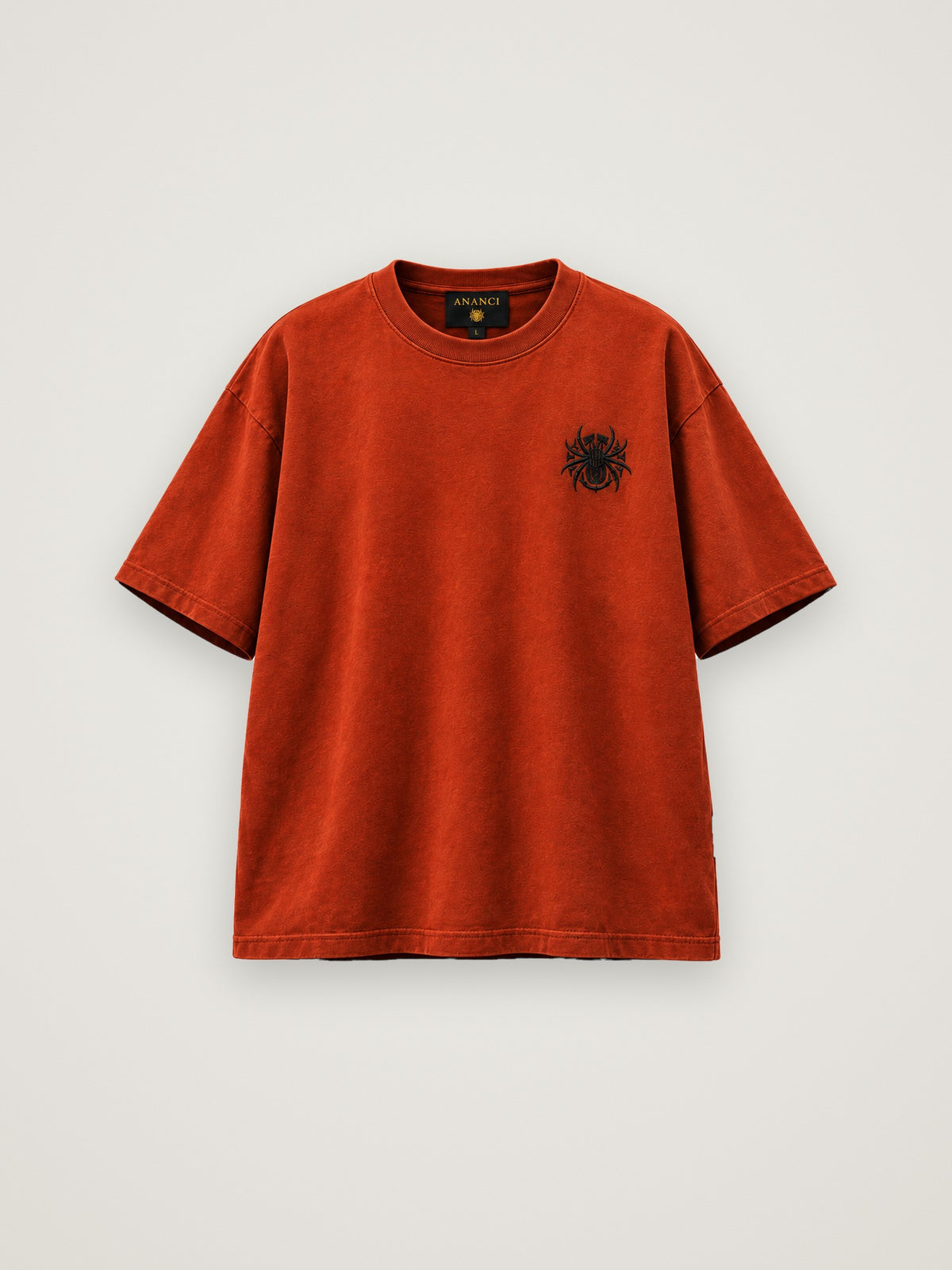 ANANCI "Archive 001" tee in deep rust, front view with the small spider emblem at the chest