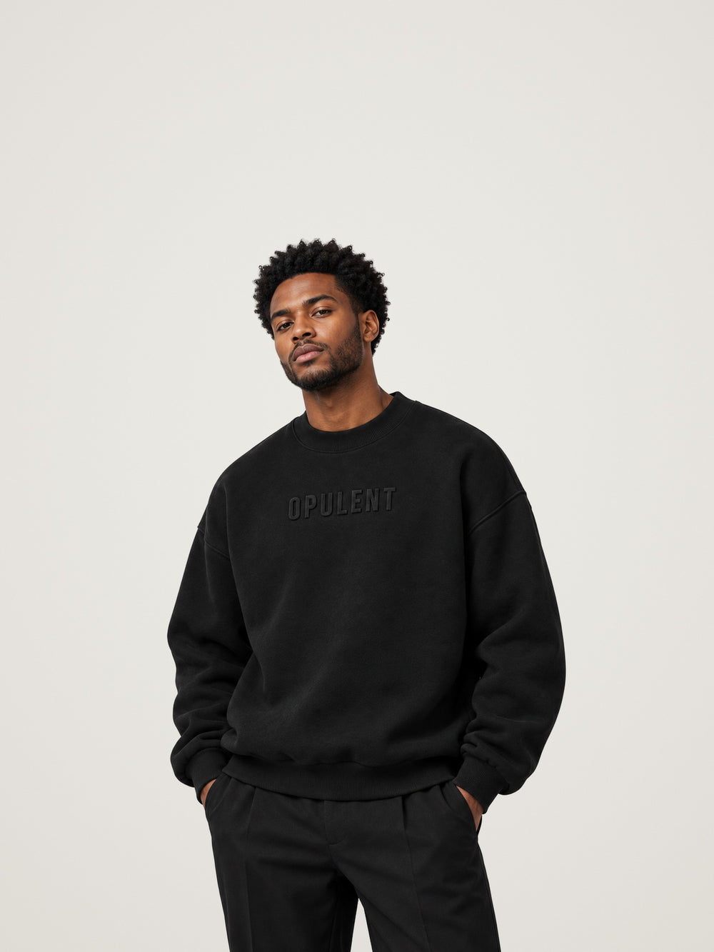 Man wearing the black ANANCI Opulent crewneck with an oversized drop-shoulder fit