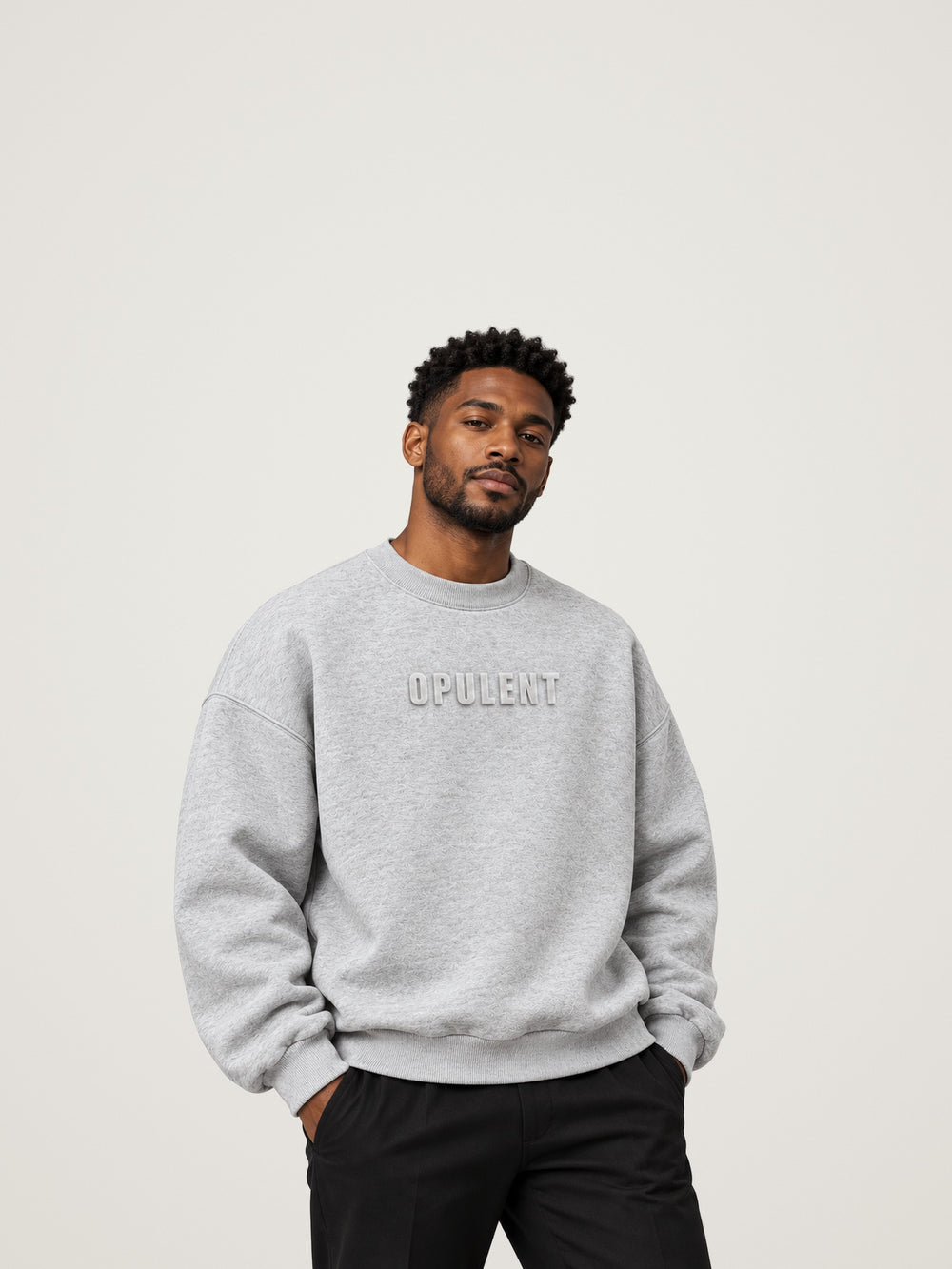 Man wearing the heather grey ANANCI Opulent crewneck with an oversized drop-shoulder fit