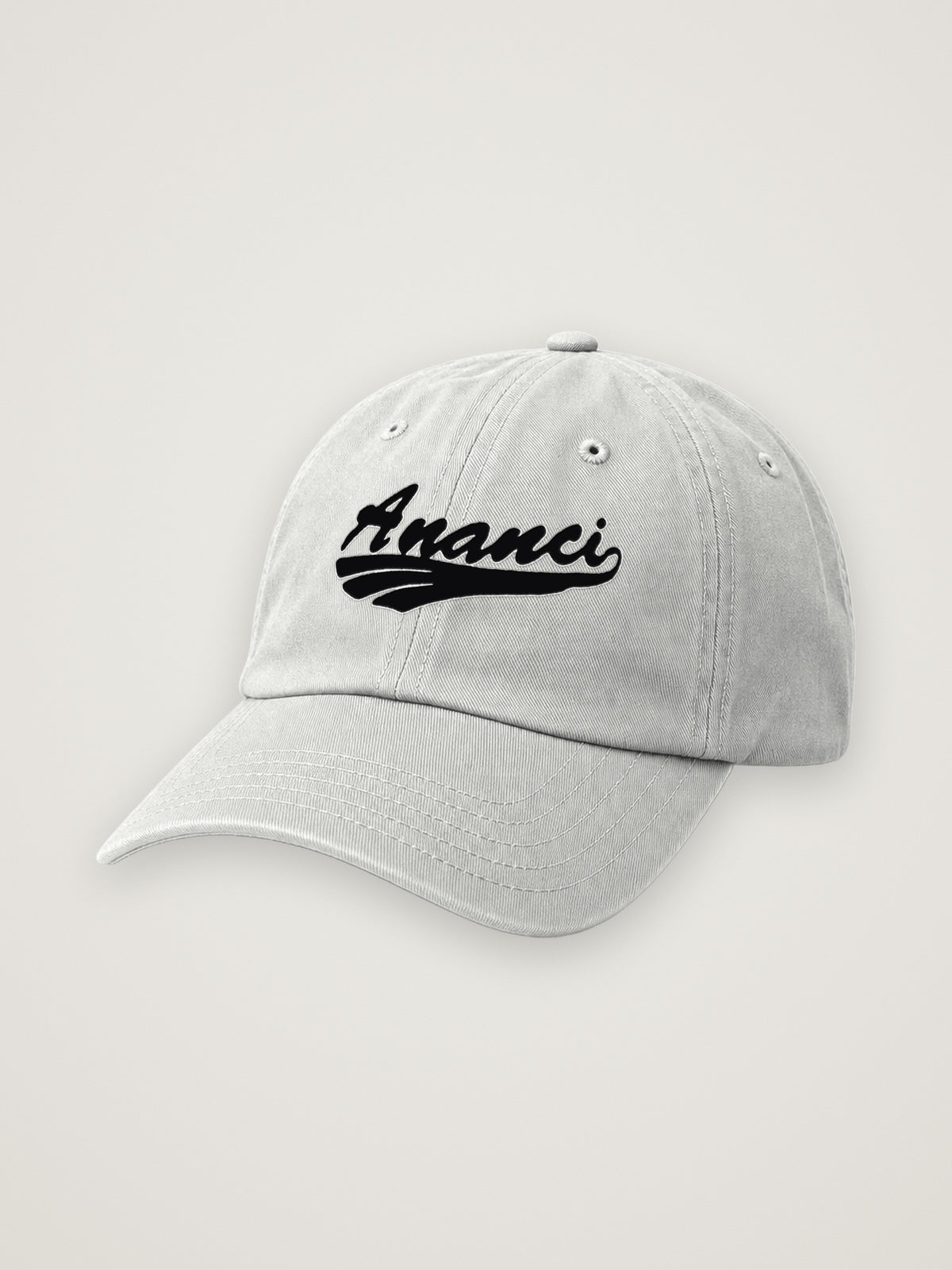 Heather Grey ANANCI script dad hat with the wordmark embroidered in black, edged in white, on a warm stone background