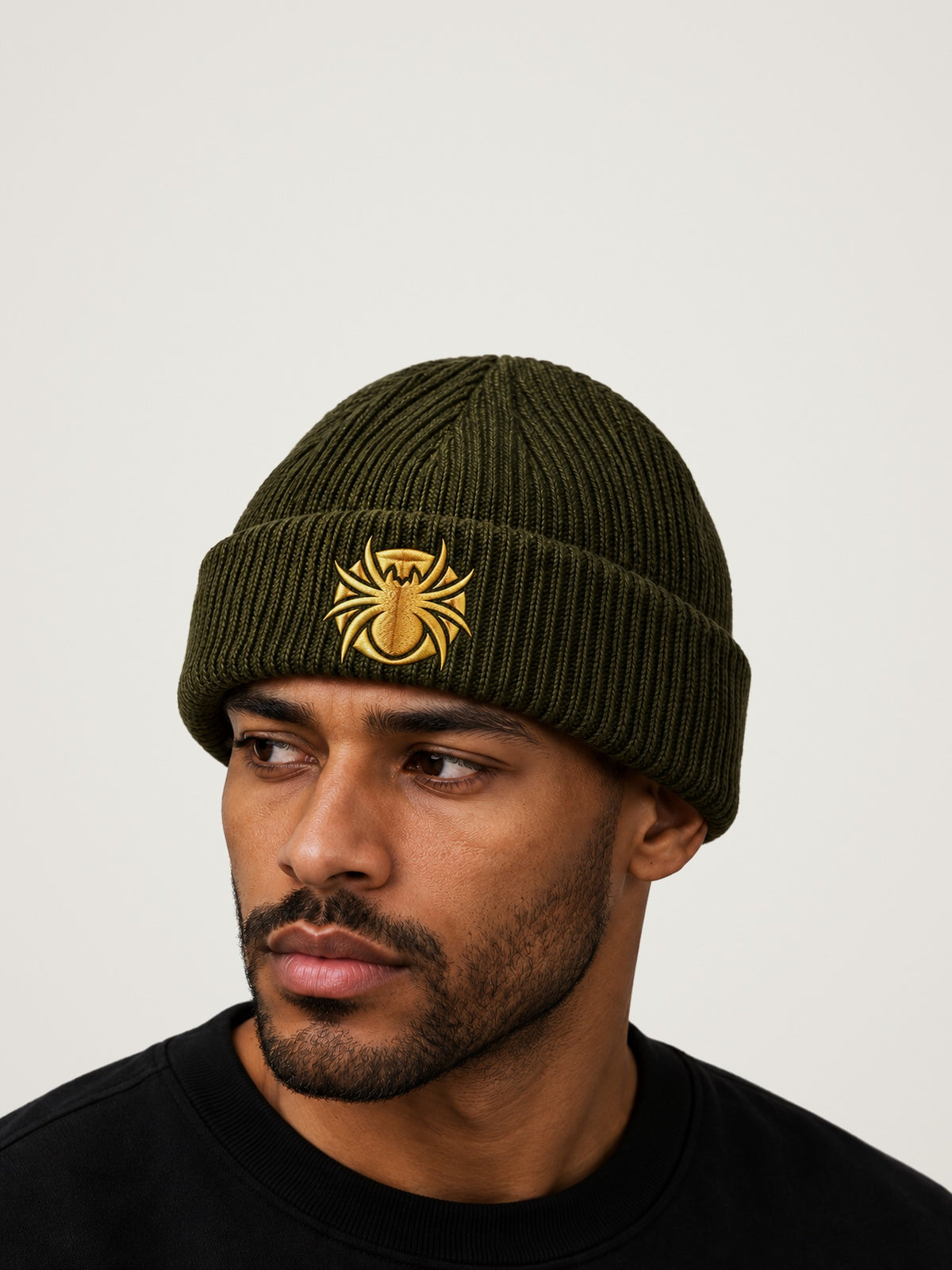 Ananci Signature Beanie in olive green with gold embroidered spider patch