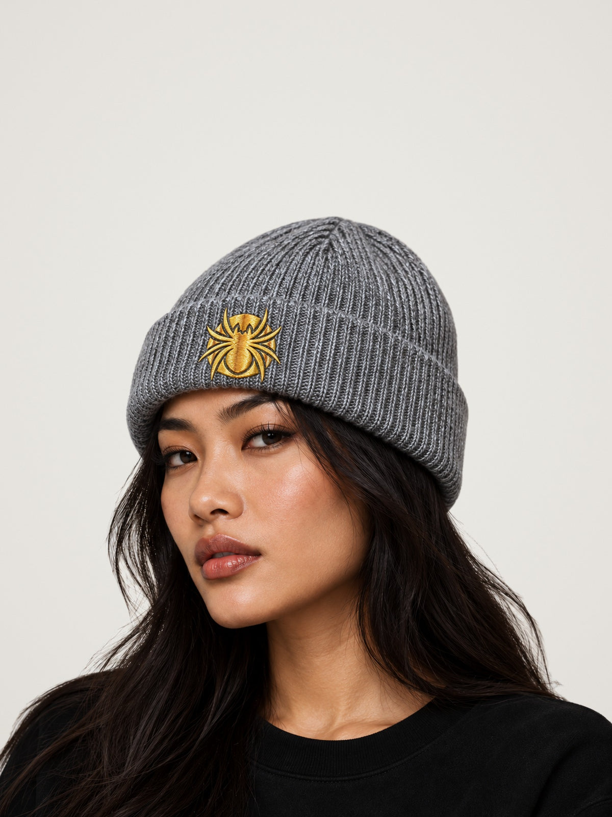 Ananci Signature Beanie in heather gray with gold embroidered spider patch