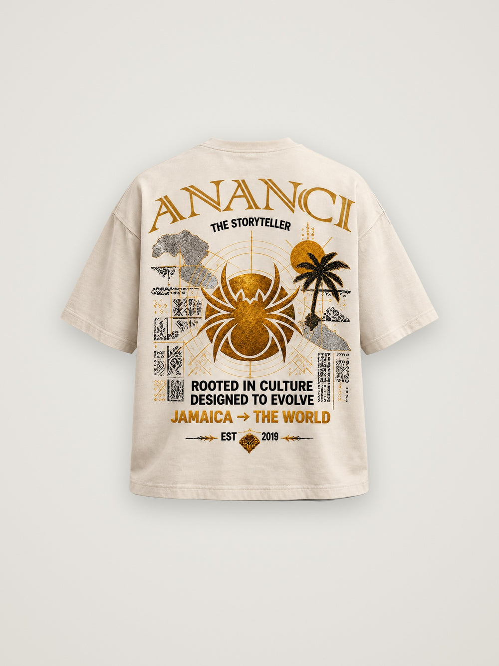 Back of the cream ANANCI "The Storyteller" tee with the gold spider, island palms and "Rooted in culture. Designed to evolve." graphic