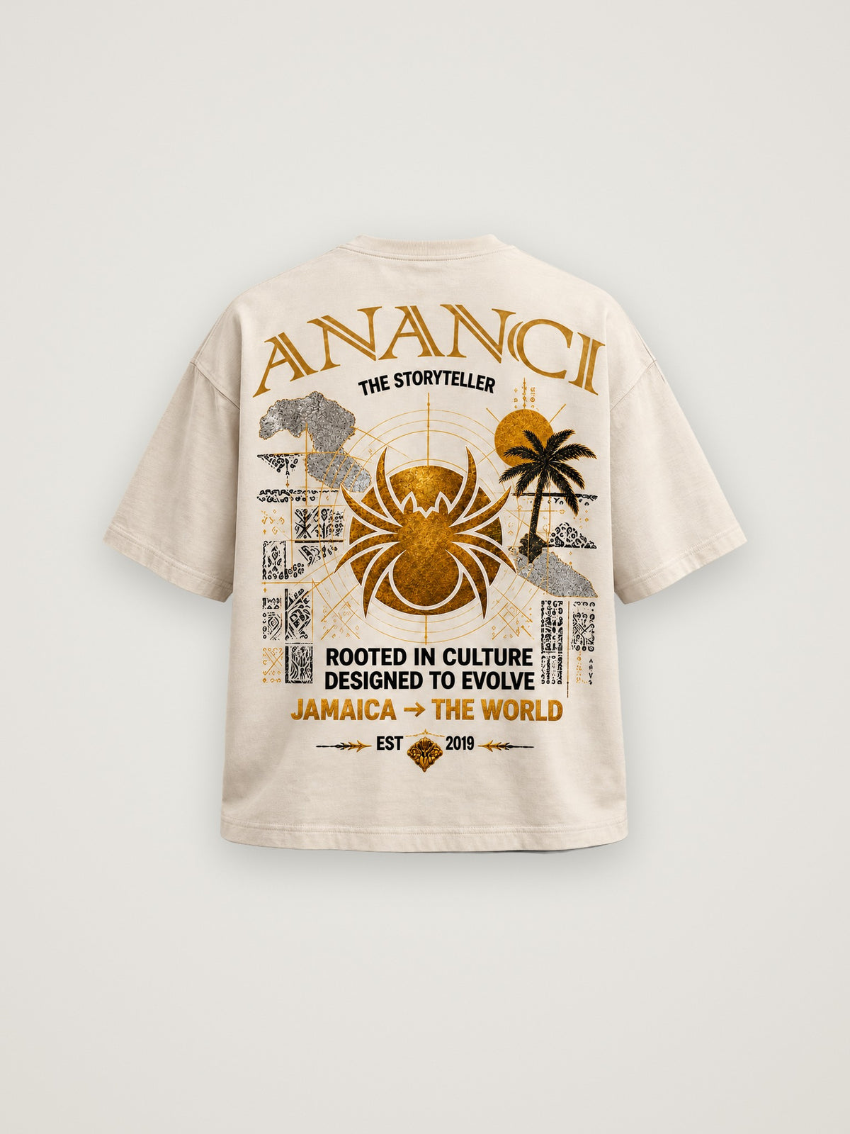 Back of the cream ANANCI "The Storyteller" tee with the gold spider, island palms and "Rooted in culture. Designed to evolve." graphic